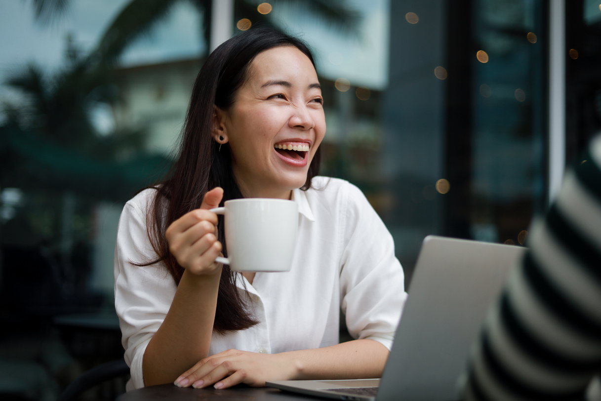 Asian woman working in cafe